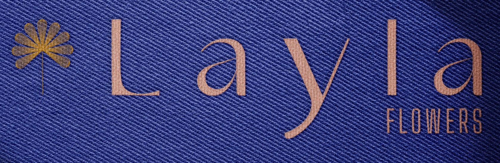 Layla Flowers logo embroidered on navy fabric
