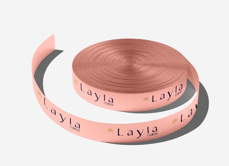 Blush satin ribbon printed with the Layla Flowers logo