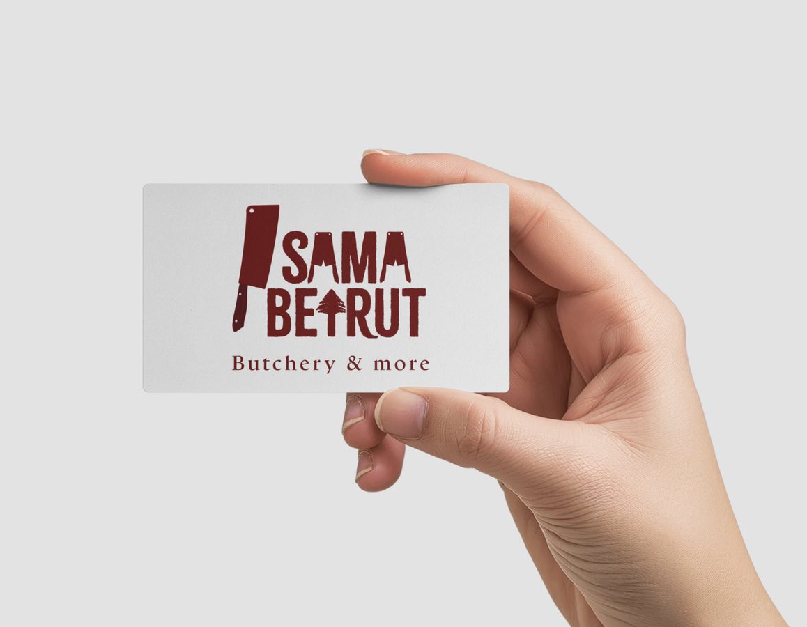 Hand holding a white Sama Beirut business card